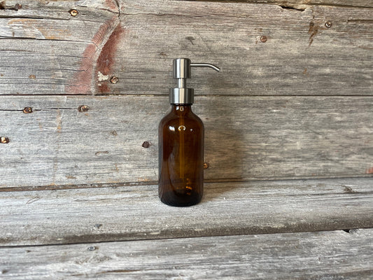Amber glass bottle with stainless pump dispenser